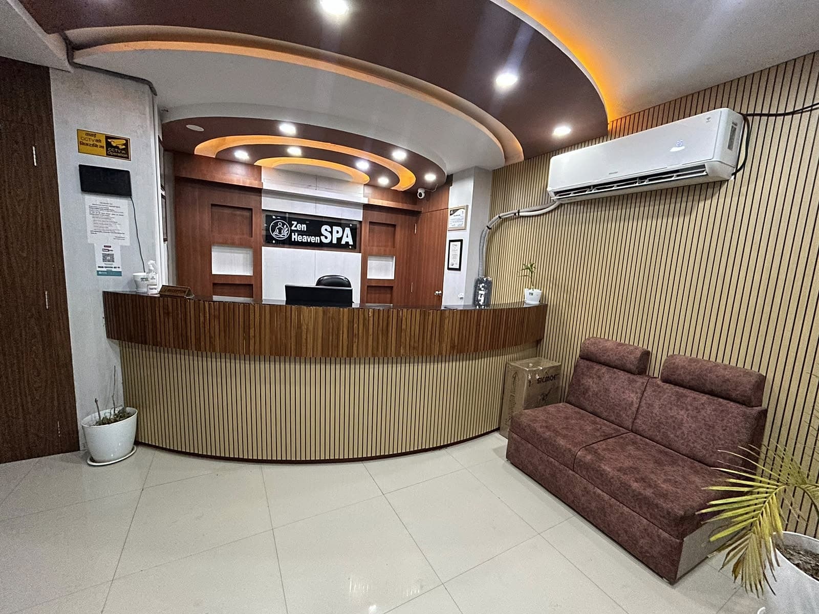 The Zen Heaven Spa reception, with a curved wooden desk beneath the spa's signboard